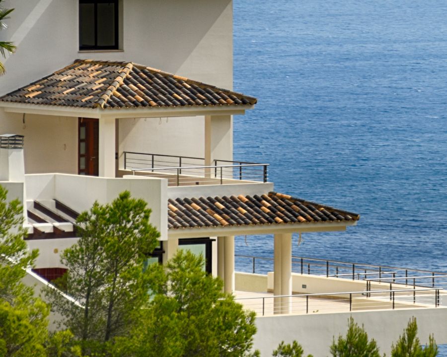 Mediterranean villas with palm trees overlooking the sea — overseas property purchase