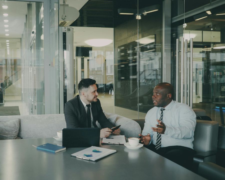 UK business team in conversation around a meeting table — international payments